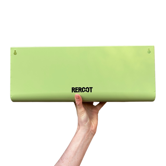 Empty stainless steel green planter held by a person's hand.