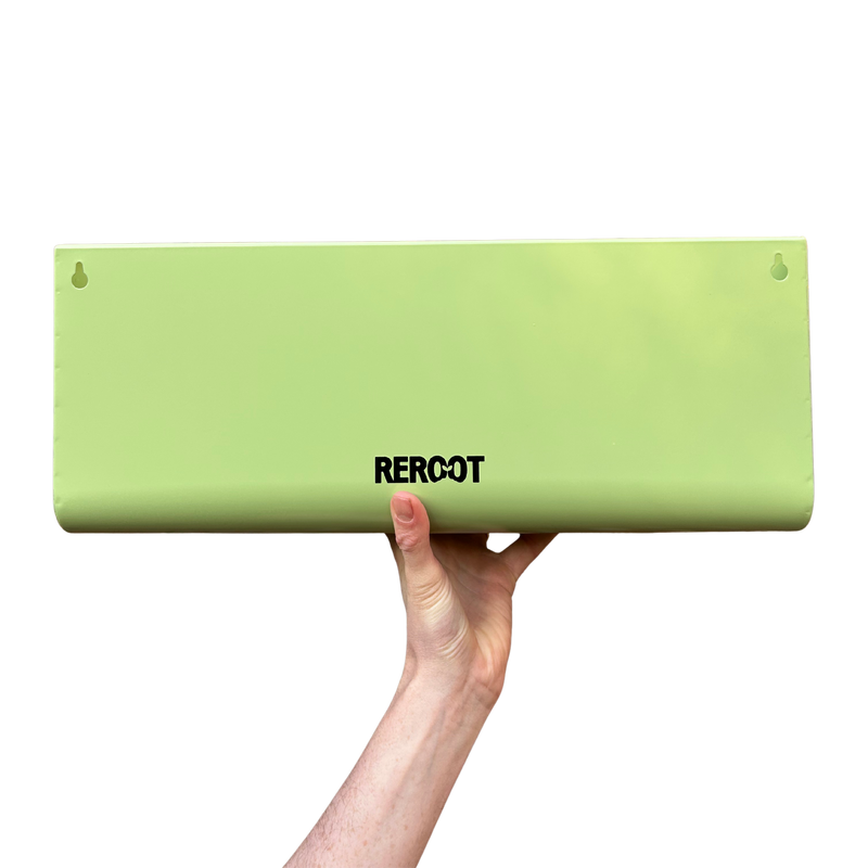 Empty stainless steel green planter held by a person's hand.